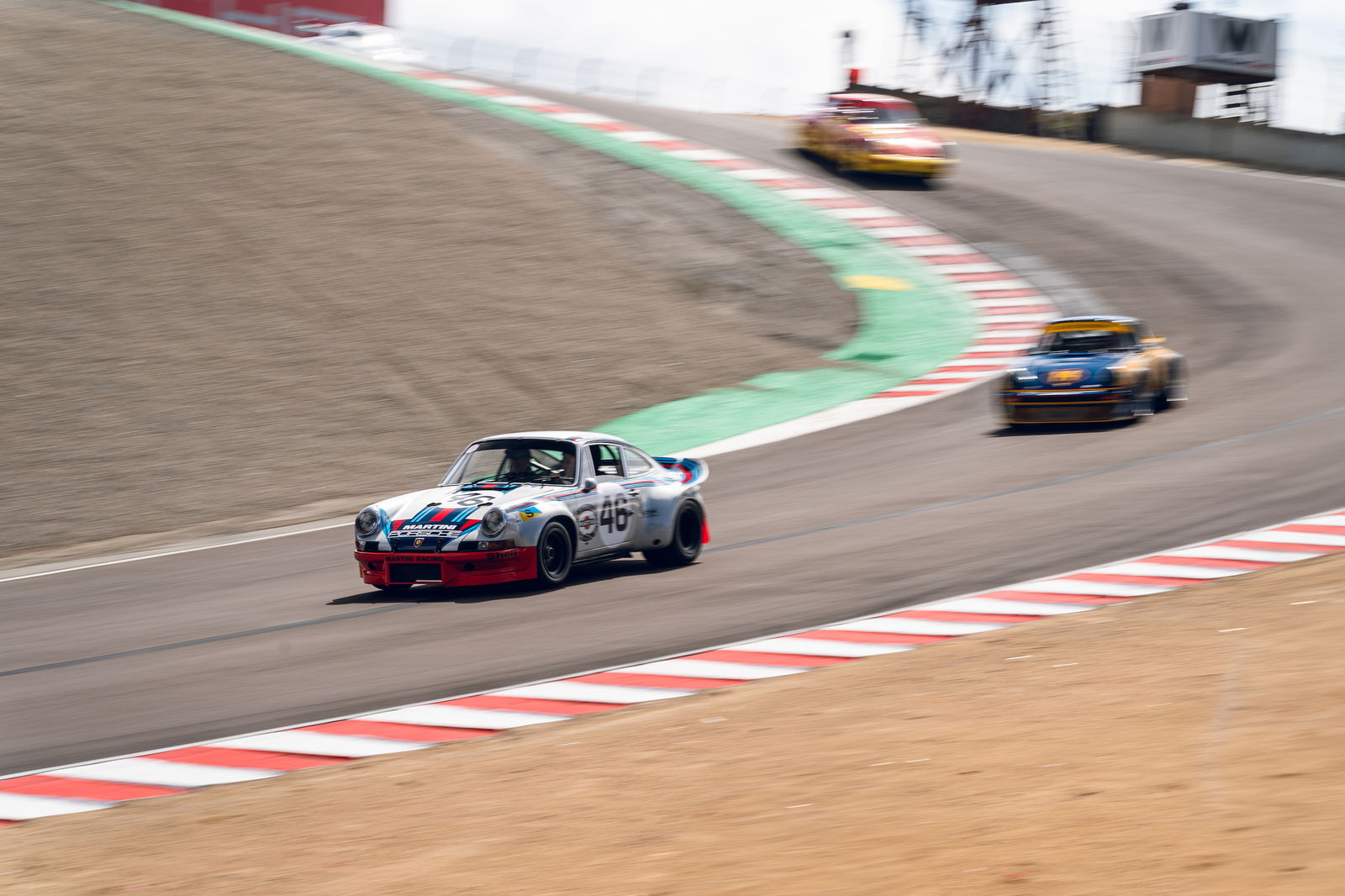 Porsche 911s battling for position on the famous Corkscrew
